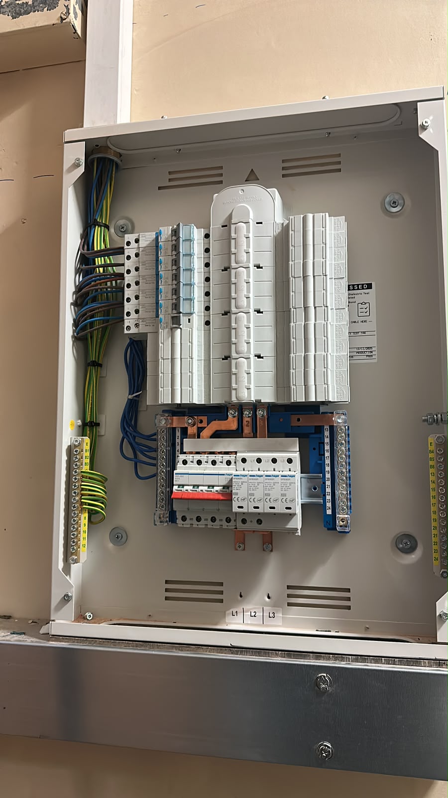 Three-phase commercial distribution board with MCBs, surge protection and neatly dressed cabling — commercial electrical installation by D.P.L Electrical Services