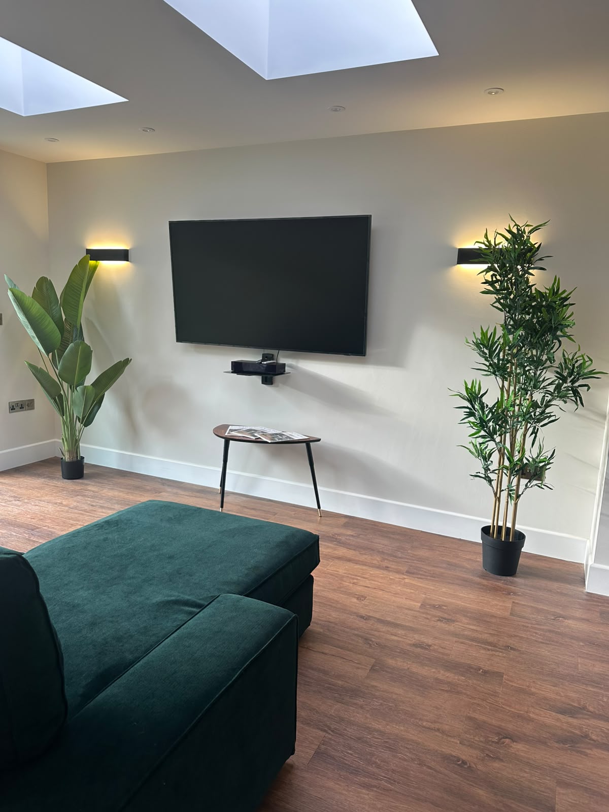 Living room detail with framed art and matched socket outlets — domestic electrical installation by D.P.L Electrical Services
