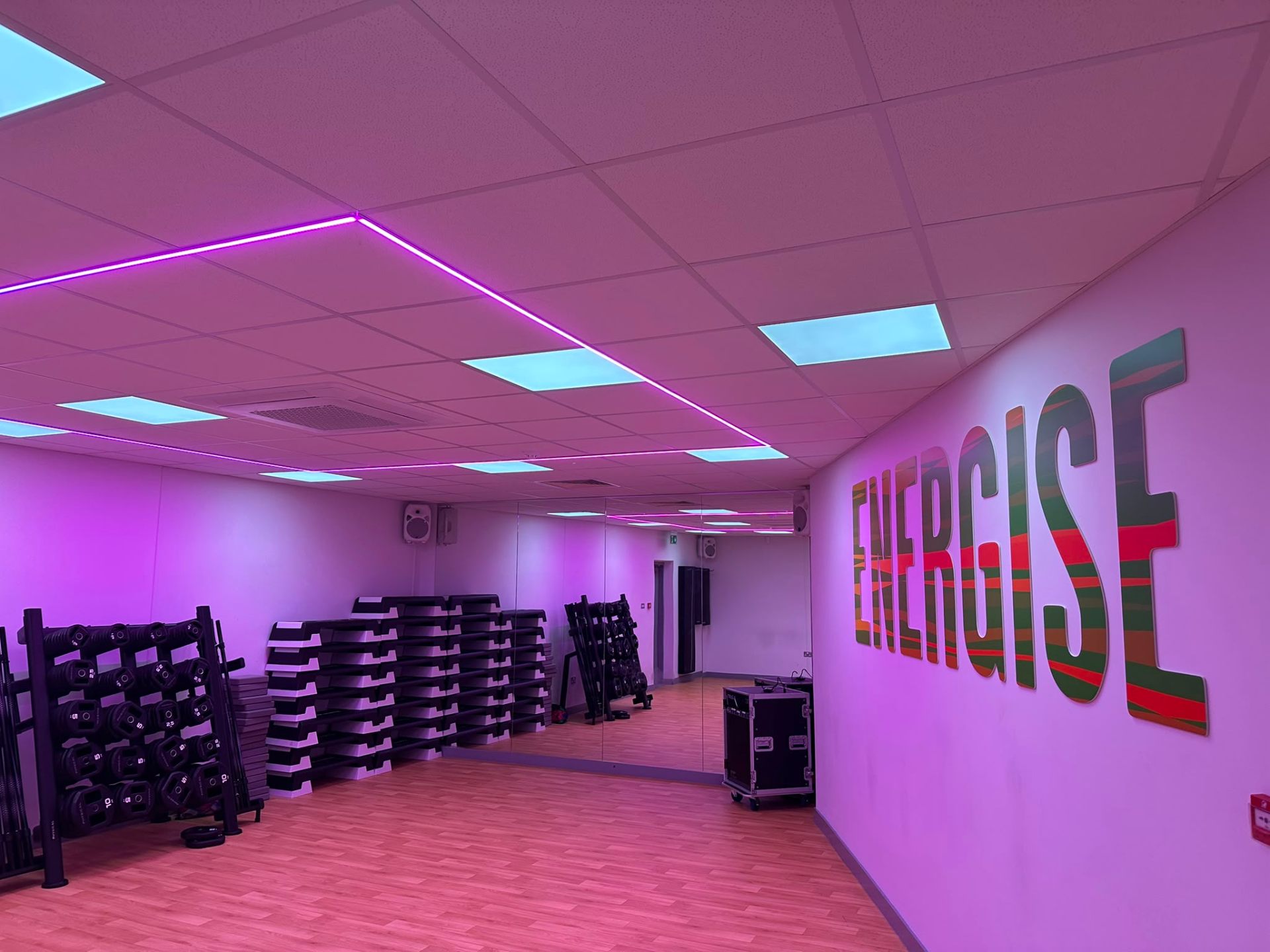 Pink RGB LED ceiling scene in a commercial spin studio — programmable colour lighting installation by D.P.L Electrical Services