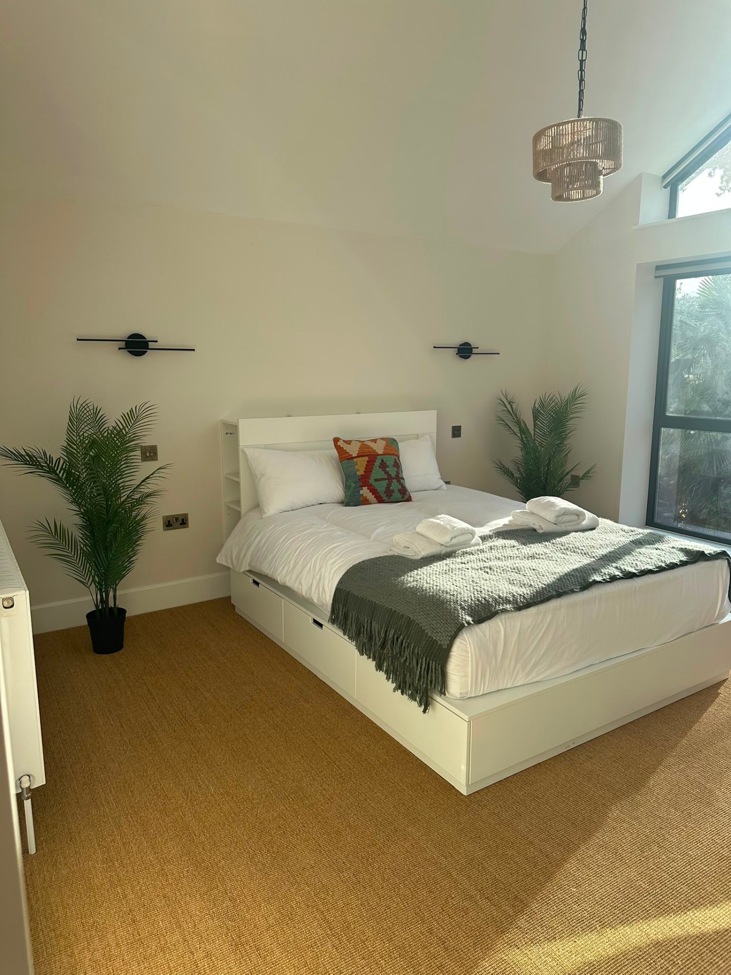 Bedroom with matched bedside wall lights and dimmable ceiling downlights — domestic bedroom lighting by D.P.L Electrical Services