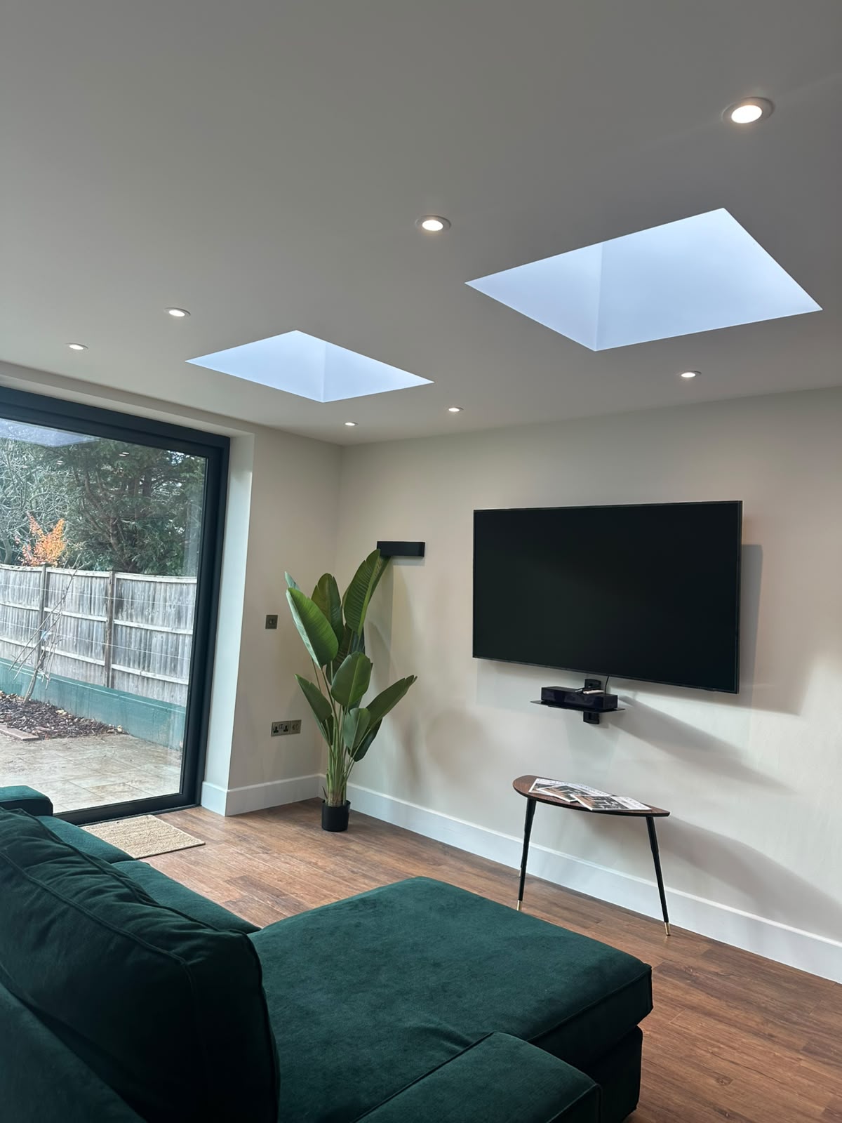 Living room with recessed downlights, skylights and wall-mounted TV — domestic electrical installation by D.P.L Electrical Services