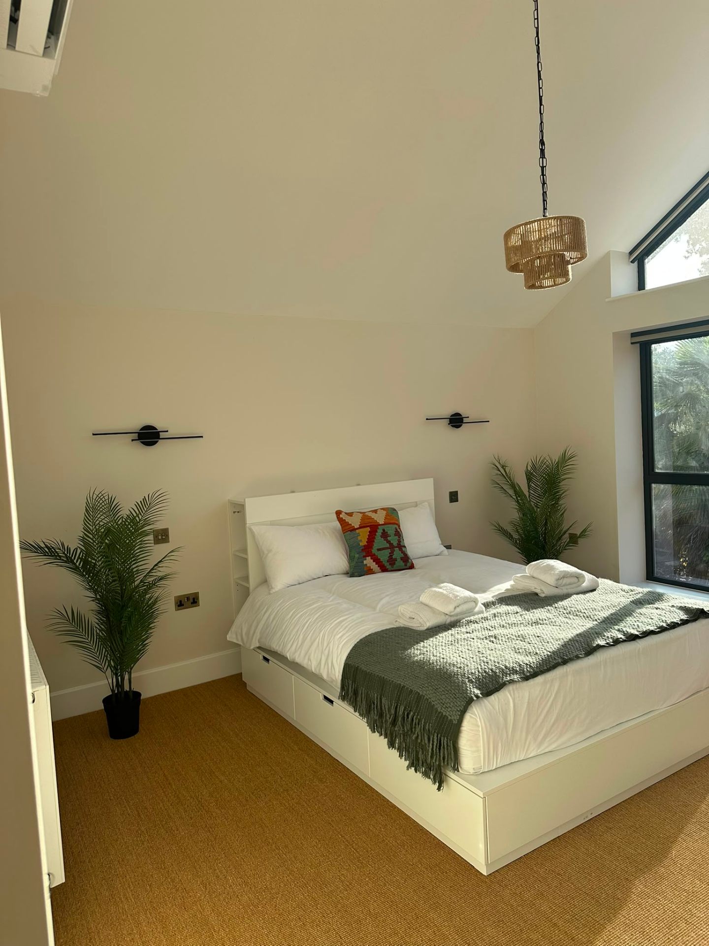 Wide-angle bedroom view with linear LED wall lights and pendant lighting — domestic lighting installation by D.P.L Electrical Services