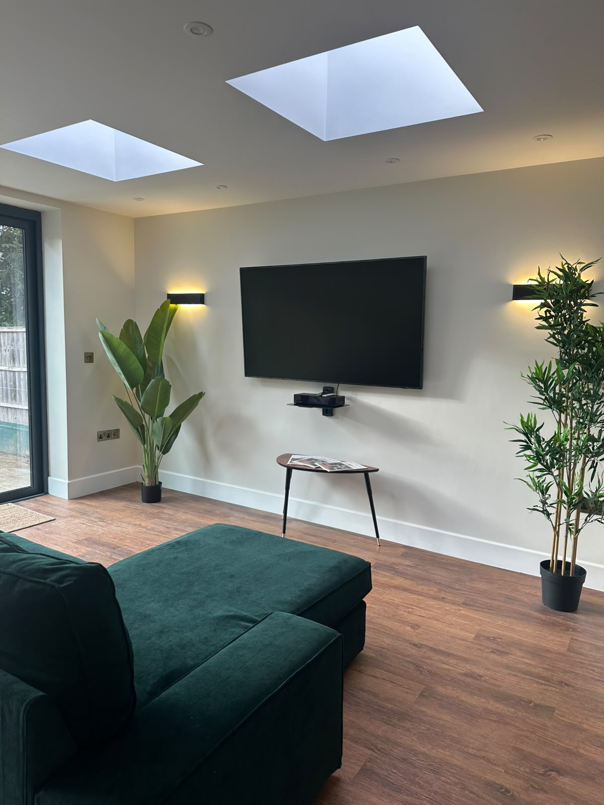 Living room with matched black up-and-down wall lights and downlights — domestic lighting installation by D.P.L Electrical Services