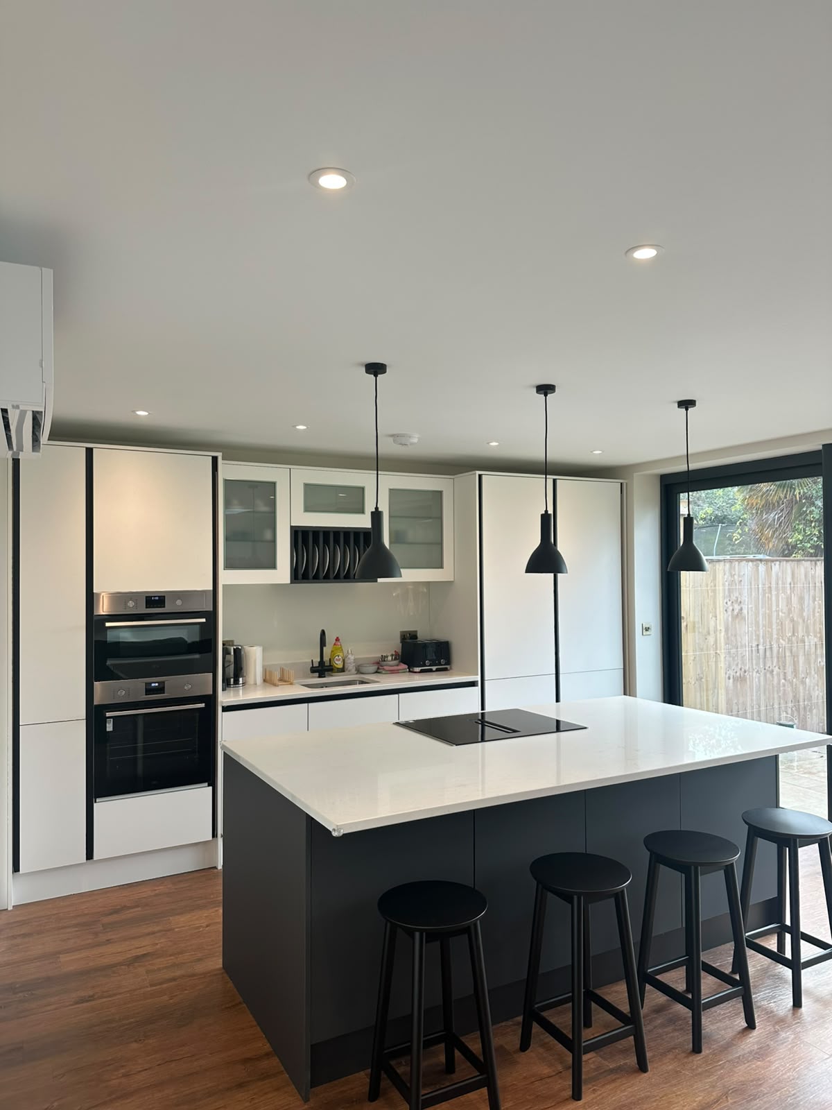 Kitchen with hood extraction and under-cabinet LED strip lighting — bespoke kitchen electrical installation by D.P.L Electrical Services