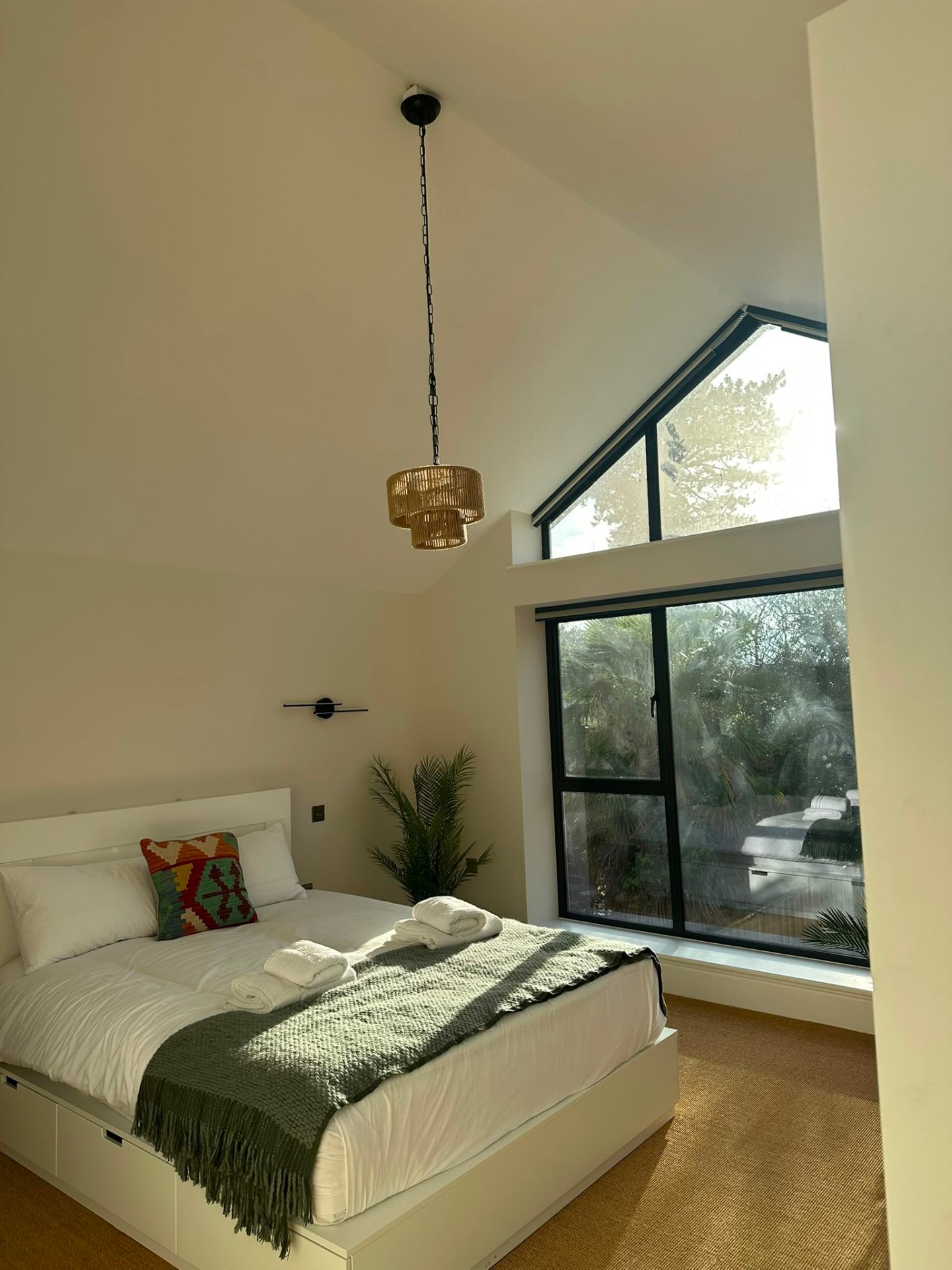 Bedroom detail with wall-mounted reading light and matched socket outlet — domestic electrical installation by D.P.L Electrical Services