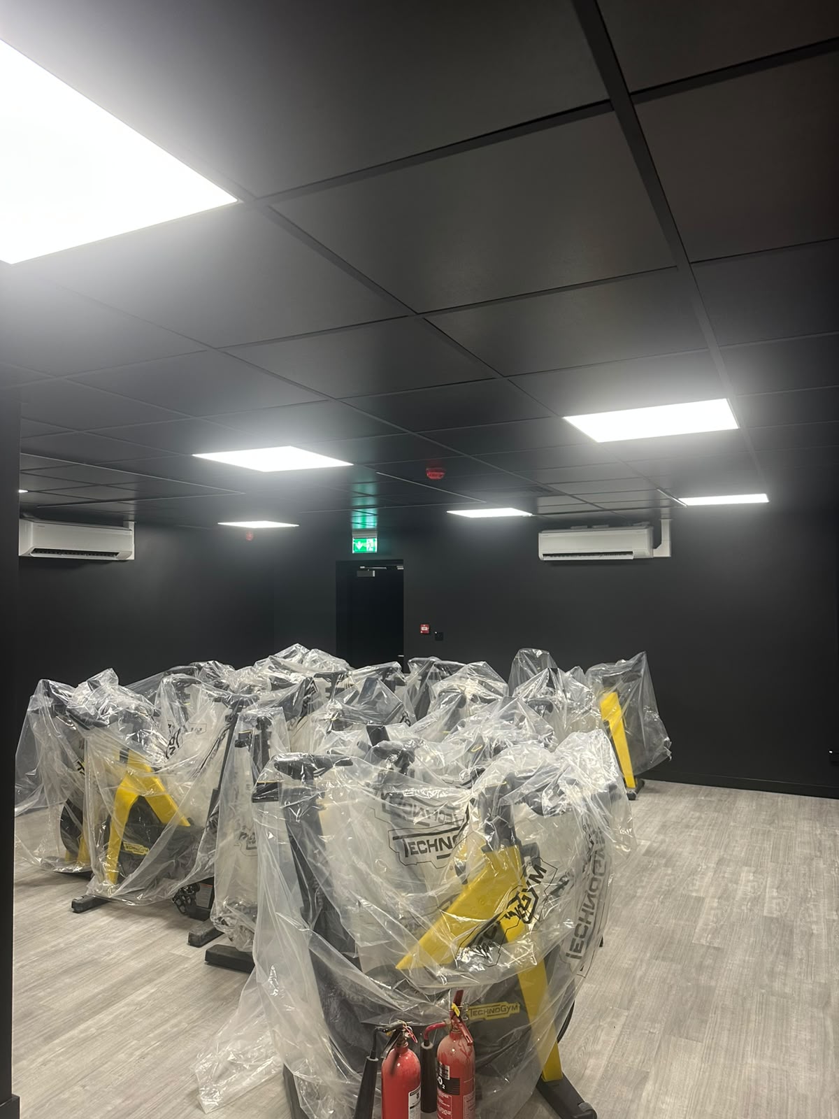 Large commercial fit-out with recessed LED panels and linear lighting installed across a suspended ceiling — commercial electrical installation by D.P.L Electrical Services