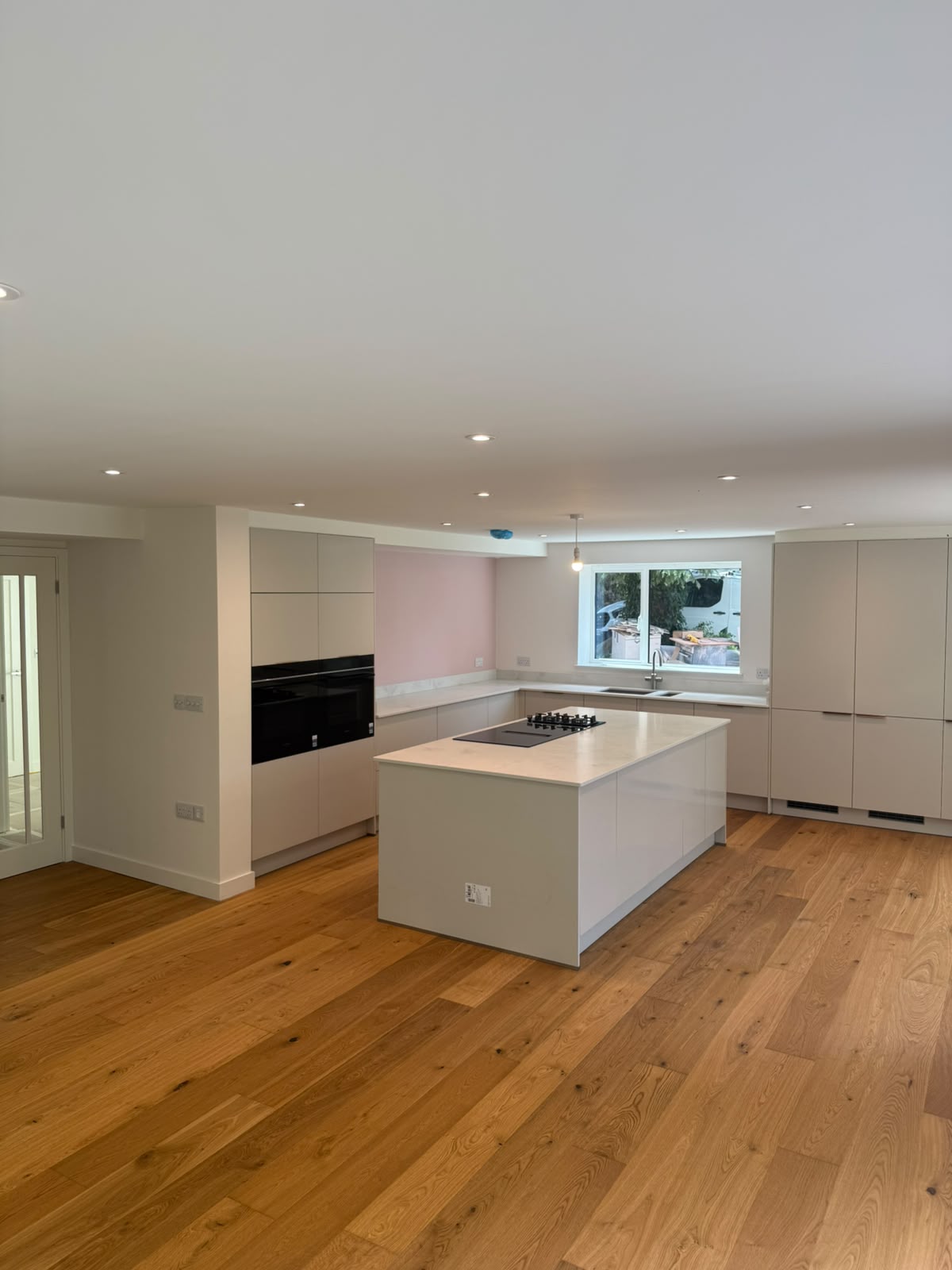 Contemporary open-plan kitchen with recessed ceiling downlights over a large island — new-build kitchen electrical installation by D.P.L Electrical Services