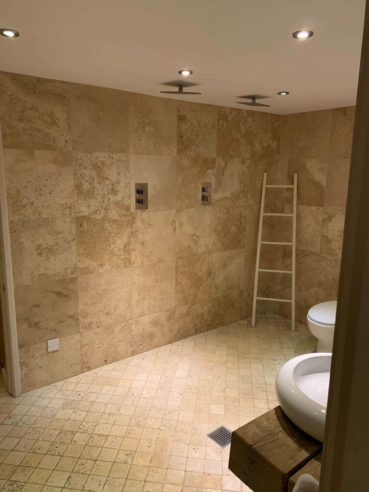 Rectangular backlit LED bathroom mirror above a floating vanity — feature bathroom lighting by D.P.L Electrical Services