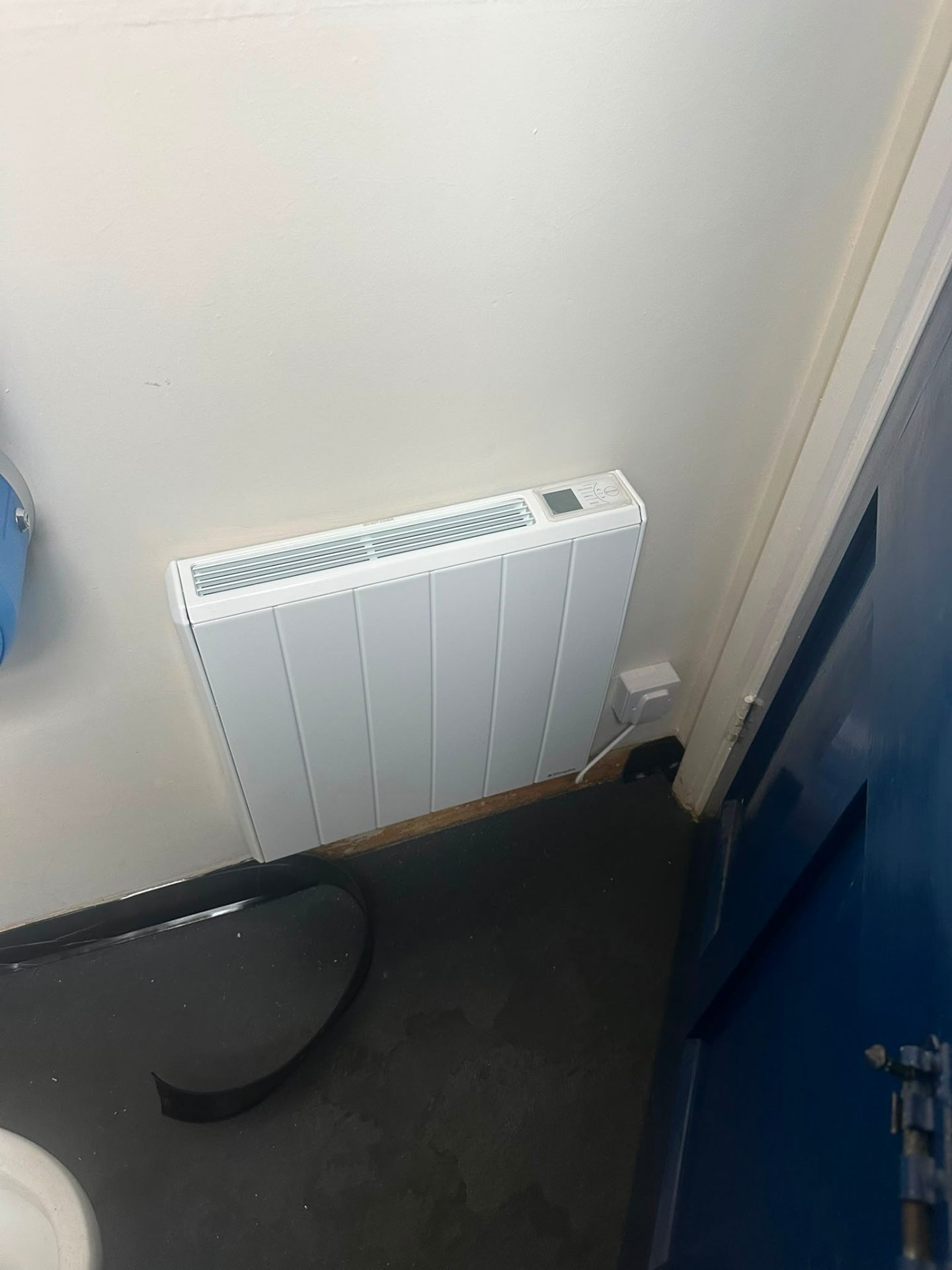 Electric storage heater installed in a small utility room — electrical maintenance by D.P.L Electrical Services