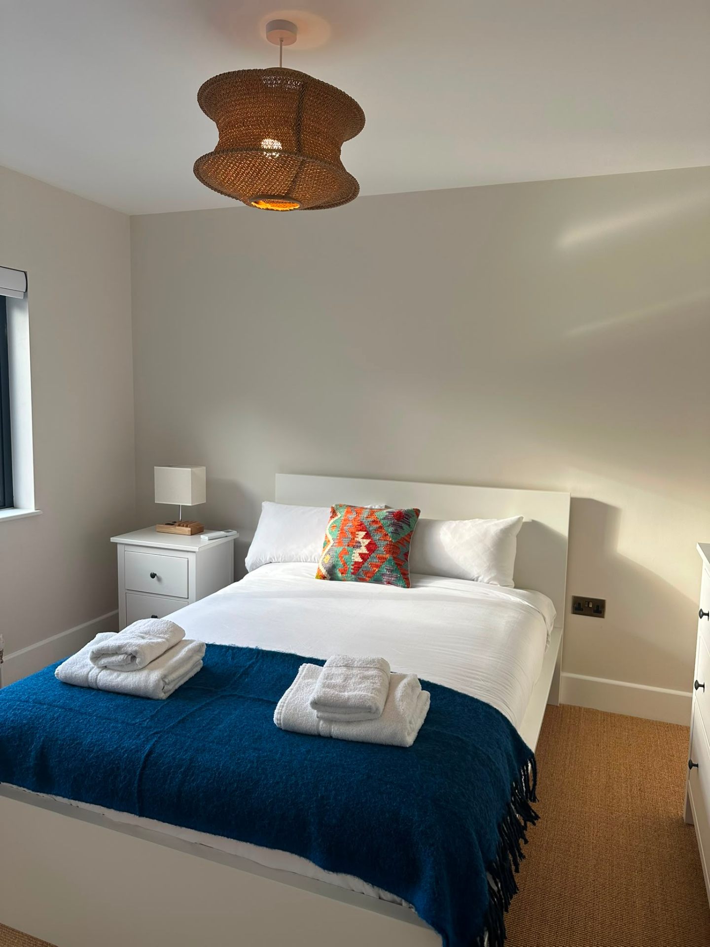 Bedside view with wall-mounted reading light and neatly finished socket — domestic bedroom electrical installation by D.P.L Electrical Services