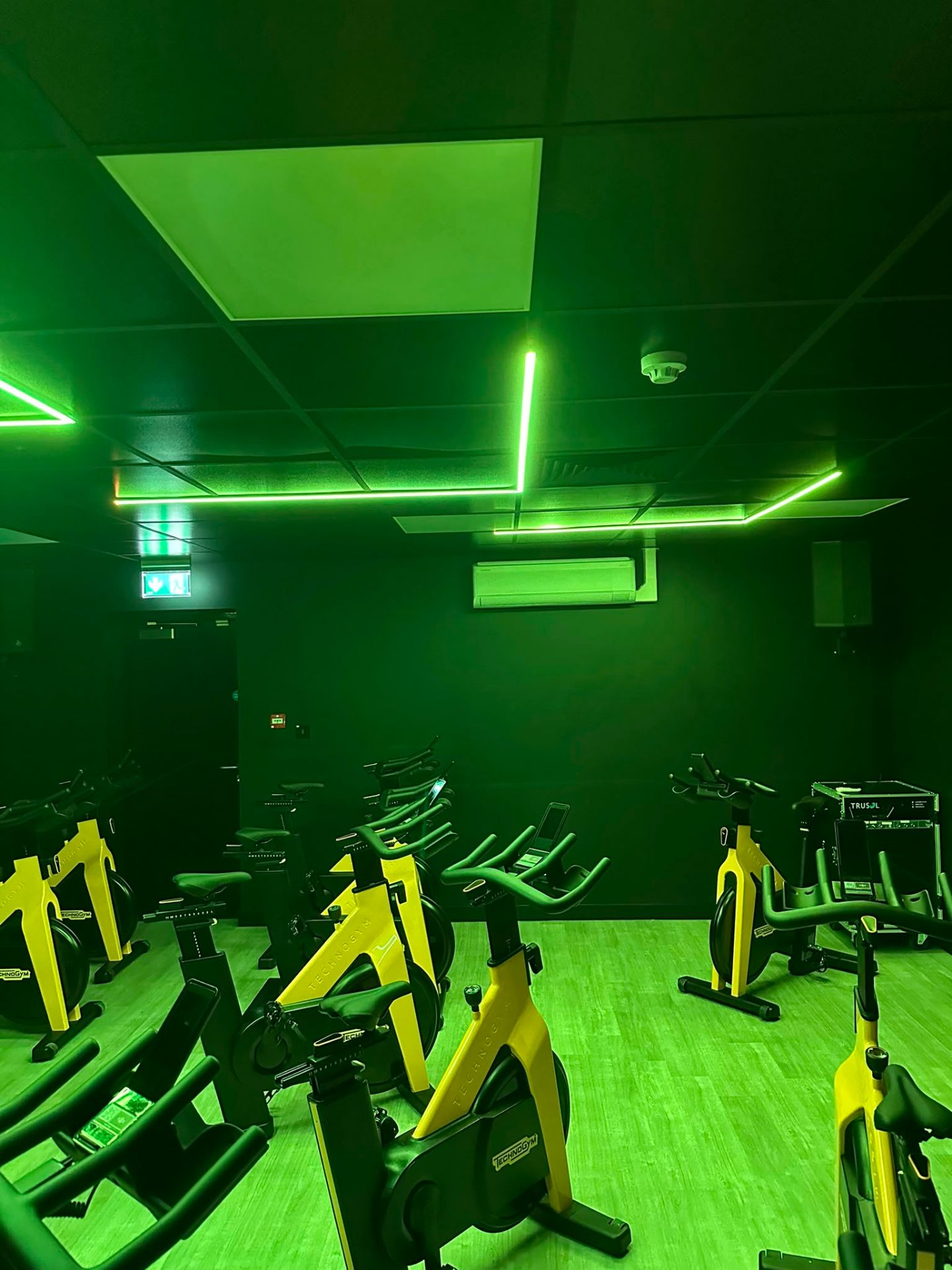Deep-blue RGB LED ceiling scene in a commercial spin studio — programmable colour lighting installation by D.P.L Electrical Services