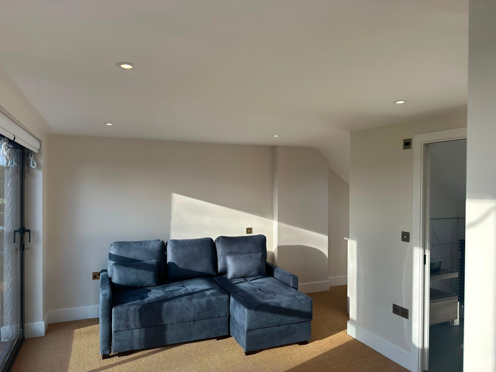Living room with matched wall lights and picture frame in the background — domestic lighting installation by D.P.L Electrical Services