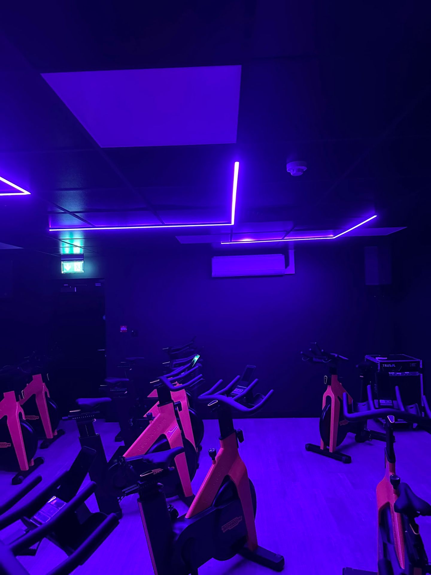 Purple LED accent lighting in a commercial spin studio — commercial lighting fit-out by D.P.L Electrical Services