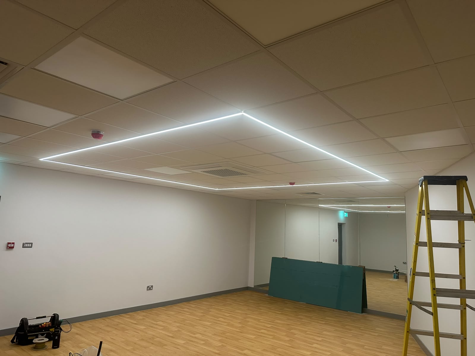 Commercial suspended-ceiling LED linear lighting installation in progress — commercial lighting fit-out by D.P.L Electrical Services